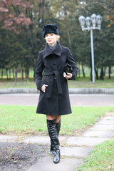 Beautiful blonde outdoors in coat and hat