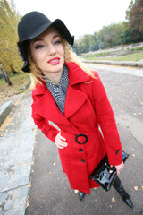 Beautiful blonde outdoors in coat and hat