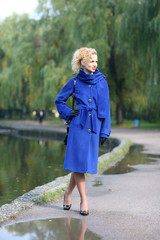 Beautiful blonde outdoors in coat and hat