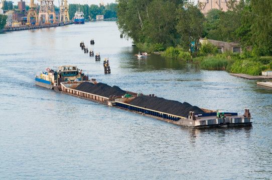 coal barge sailing on the river