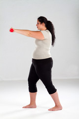 Fototapeta na wymiar overweight woman lifting weights