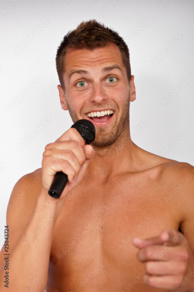 Wall mural Young man singing karaoke