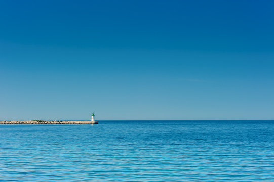 Beacon on pier in Adriatic Sea. Copyspace background.