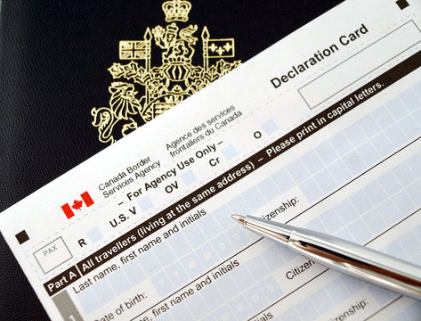 Canada passport on declaration card with pen