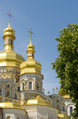 Gold domes of Orthodox Church with cross