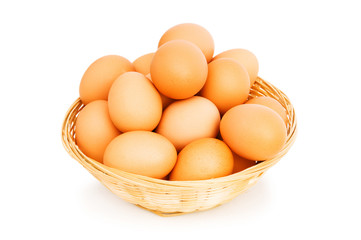 Brown eggs in the basket on white