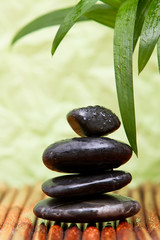 Fototapeta na wymiar Massage stones and bamboo leaves