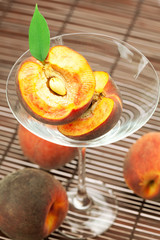 peach in the martini glass on a bamboo mat