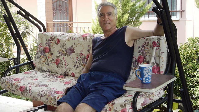 Old retired man on porch swing - Retirement Home