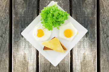 fried eggs and gold cheese with salad