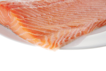raw salmon fillet on white plate