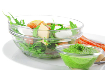 salad with salmon in transparent bowl