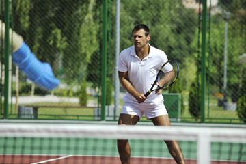 young man play tennis outdoor