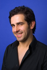 Young casual atractive man portrait, on a blue background
