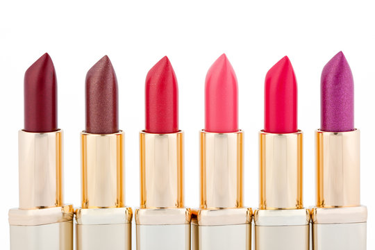 Multicolored color lipsticks arranged in line isolated on white