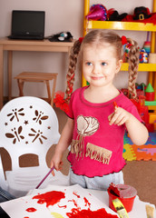 Child paint picture in preschool.