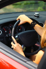 young woman in a red car