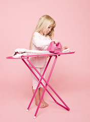 Little girl ironing dress