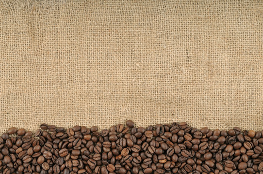 Coffee beans on brown jute background