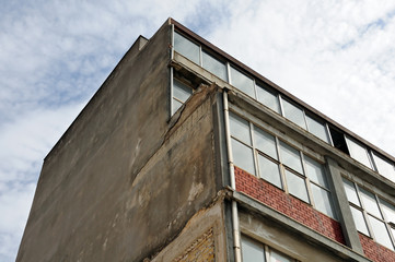 Old industrial building exterior and grungy wall.