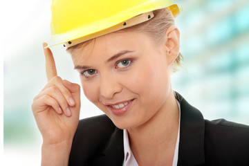 Confident female worker in helmet