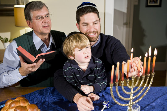 Jewish Family Lighting Hanukkah Menorah