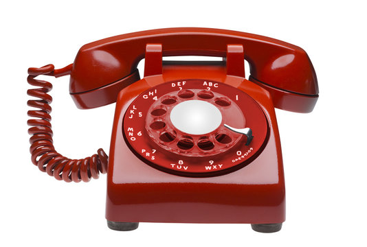 Red angled 60s rotary dial phone isolated with clipping path