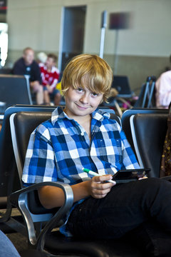boy is waiting for departure at the airport
