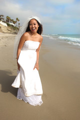 Fototapeta na wymiar Bride On the Beach Walking in Sand