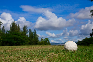 Golfball on course and blue sky