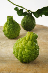 three kaffir lime on wood background
