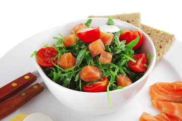 salad with salmon in white bowl