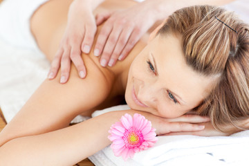 Fototapeta na wymiar Blissful young woman enjoying a back massage