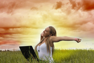 Young  teenager girl  in natural environment with laptop.
