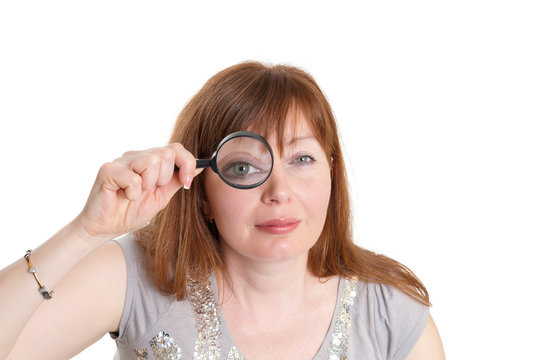 woman looks through a magnifier