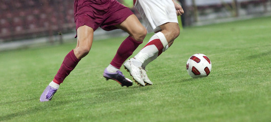 Soccer players running after the ball