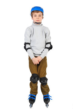 little boy with with crossed hands in blue helmet rollerblading
