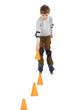 boy with cone in hand rollerblading near orange cones