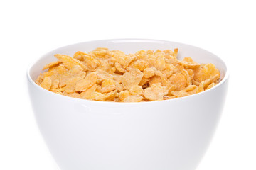 Bowl with corn flakes and milk on the white background