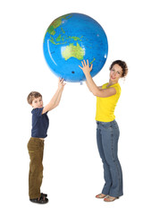 mother and son holding big inflatable globe and looking