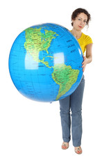young curl woman in yellow shirt holding big globe and looking