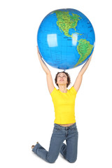 young woman in yellow shirt sitting and holding big globe