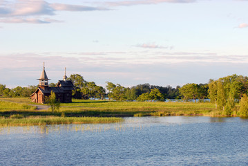 Naklejka premium Small wooden church in Kizi.Sunset.
