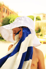 Girl dried her face with a towel - obrazy, fototapety, plakaty