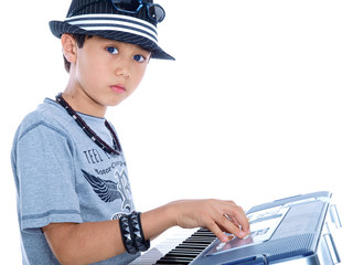 boy playing electric music keyboard isolated on white