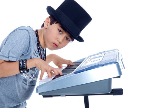 Cute Boy Playing Electronic Music Keyboard Isolated On White