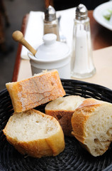 little roll breads in basket on table