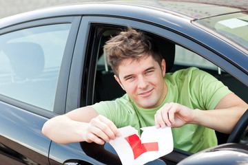 Happy young man cutting a 