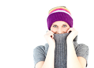 Young woman wearing a colorful hat and a grey pullover