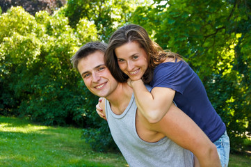 Young man and young woman in the nature have fun